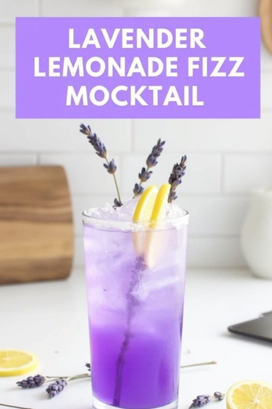 Refreshing lavender lemonade fizz mocktail with lemon slices and lavender sprigs in a tall glass on a kitchen counter.