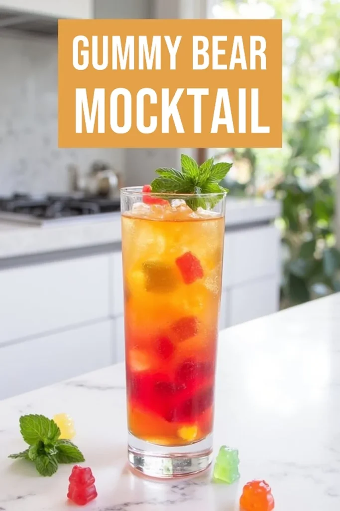 Colorful gummy bear mocktail garnished with mint leaves on a kitchen counter. Refreshing non-alcoholic drink.